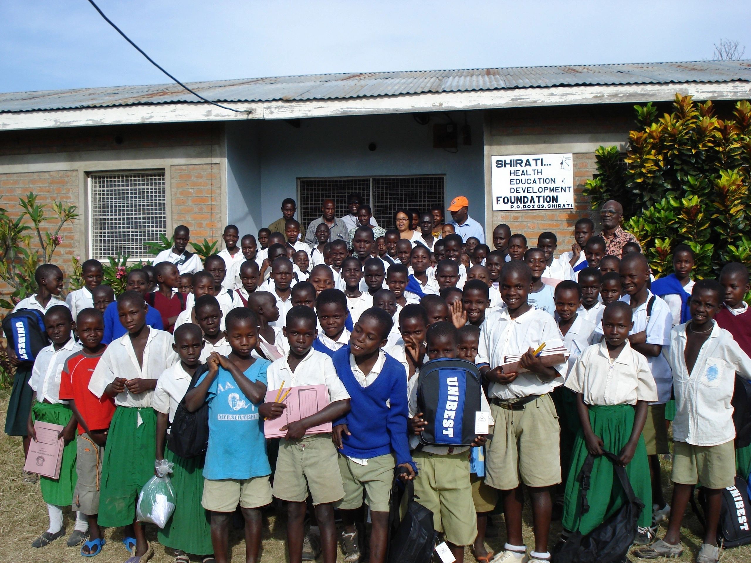Schoolchildren with SHED Foundation staff outside the SHED office in Shirati