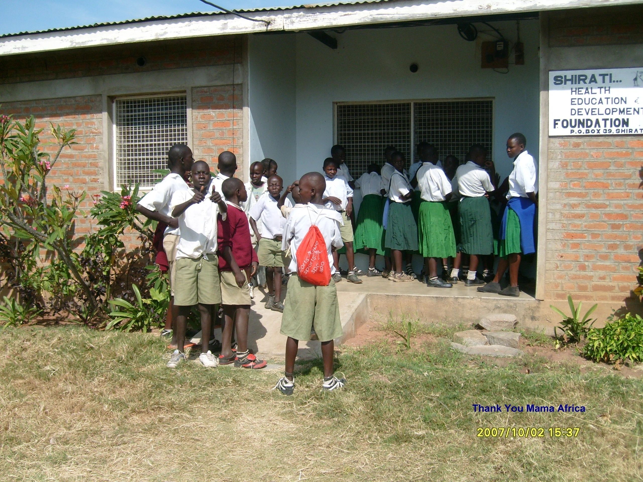 Community health worker with patients in Shirati